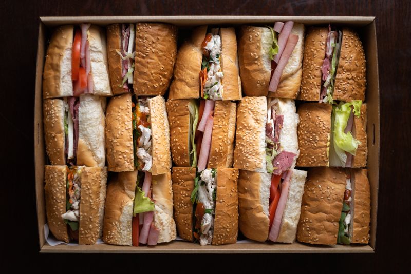 Catering spread with firehouse sub sandwiches for a large group
